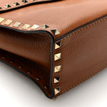 Pebbled Calfskin Rockstud Flip Lock Top Handle Bag Cognac