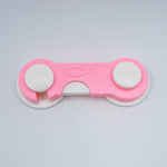 Pink and white tool with a fish symbol on a light gray background